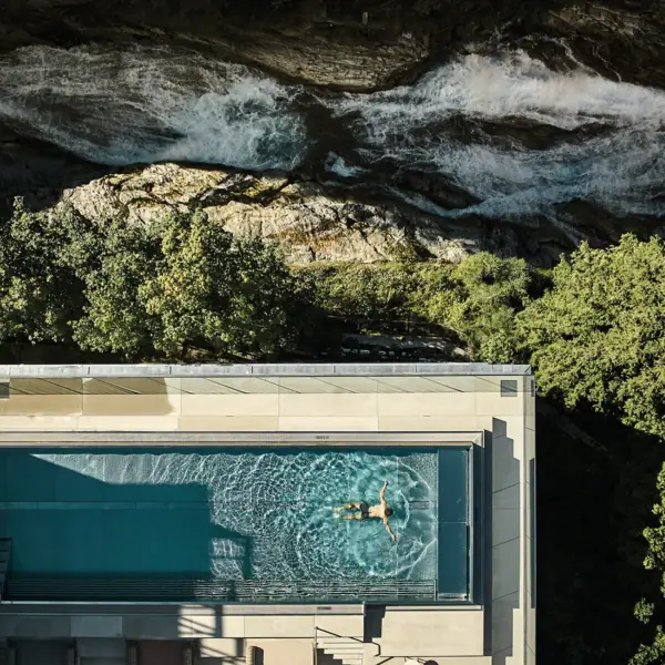 Person swims in an outdoor pool.