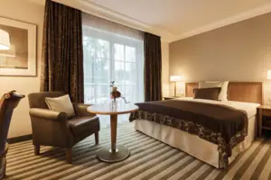 A room with a bed and a chair.