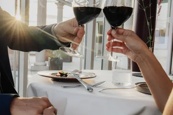 A couple holding wine glasses.