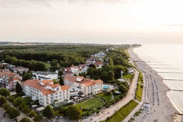 Aerial view of a beach with buildings and trees.