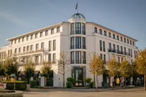 A building with trees and a flag on the roof.