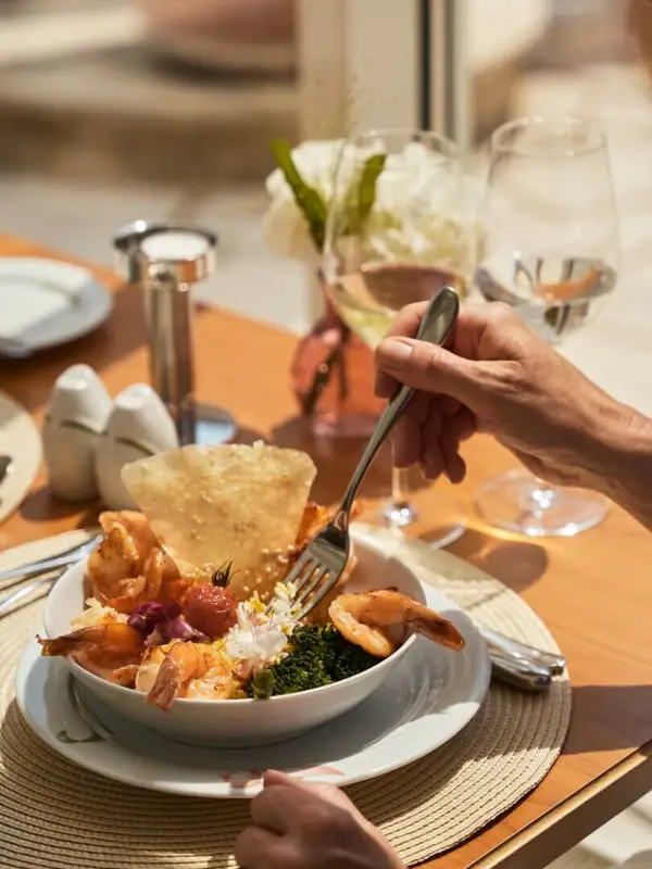 A person eating a bowl of food at a table.