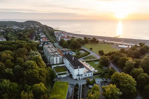 Aerial view of a town with trees and a body of water.