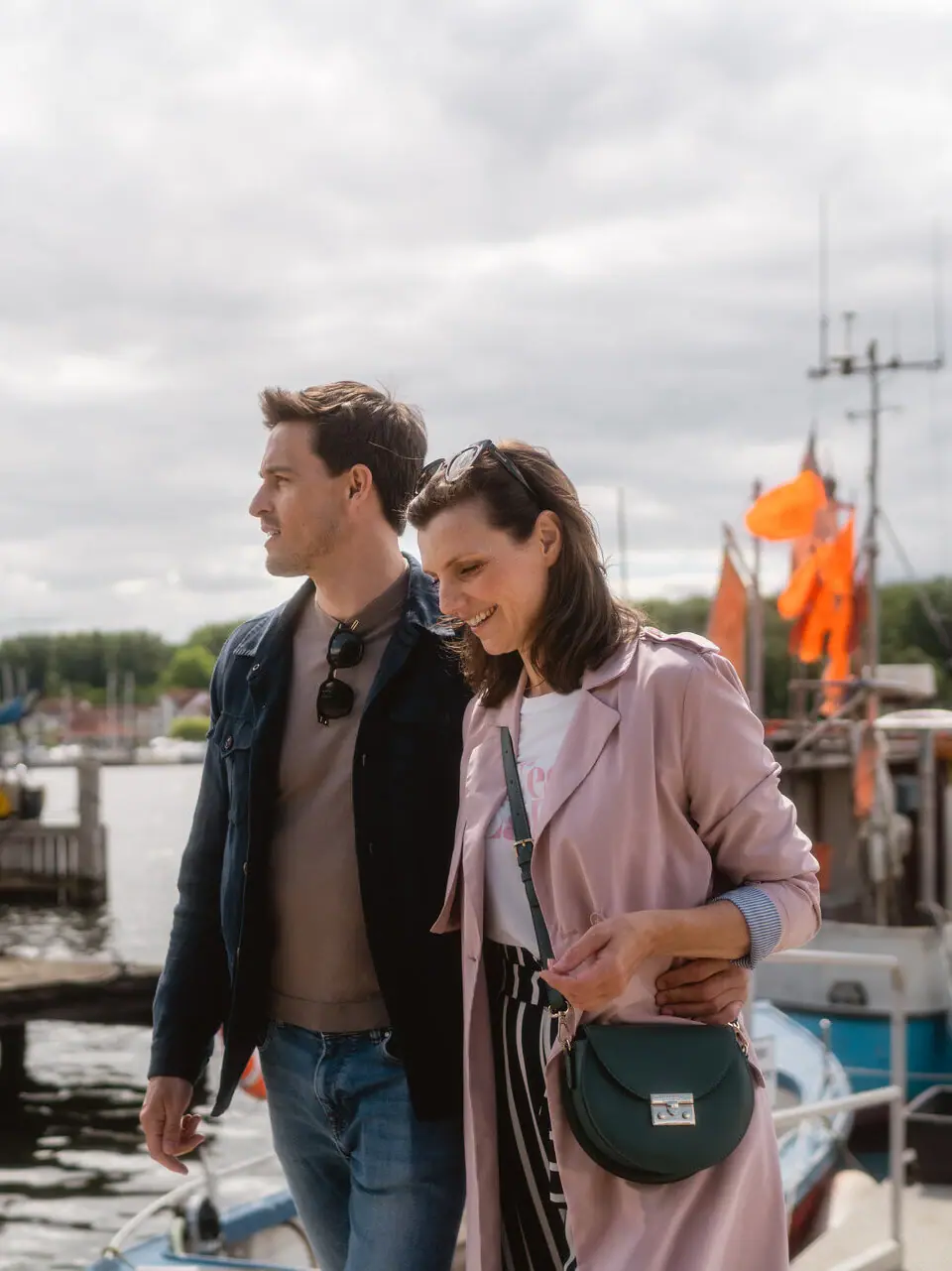 Couple at Travemünde fishing harbour A man and a woman are standing on a jetty.