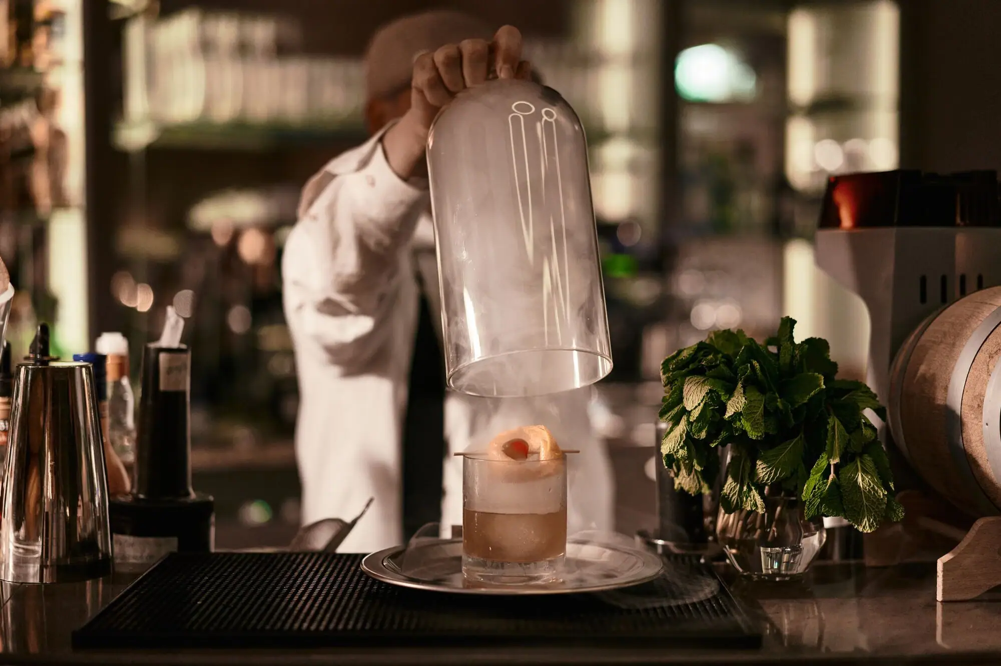 Kurhaus Bar A person pouring a glass into a drink indoors.