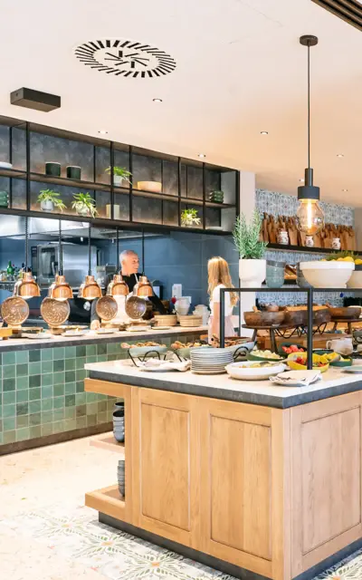 Buffet in a restaurant with various dishes on a counter.