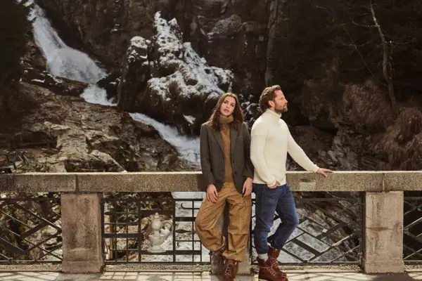 Couple at Straubinger Grand Hotel Bad Gastein enjoying the waterfall view in Salzburger Land across the seasons.