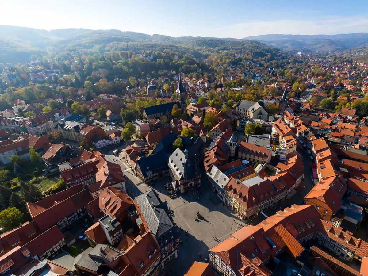 Aerial view of Wernigerode with mountains in the background.