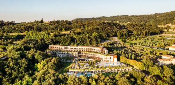 A building surrounded by trees in a natural landscape.