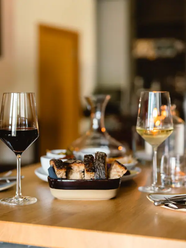 A table with food and wine glasses.