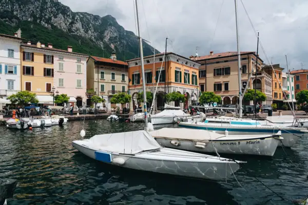 Gargnano Boats in the harbour, with buildings and mountains in the background, on Lake Garda.
