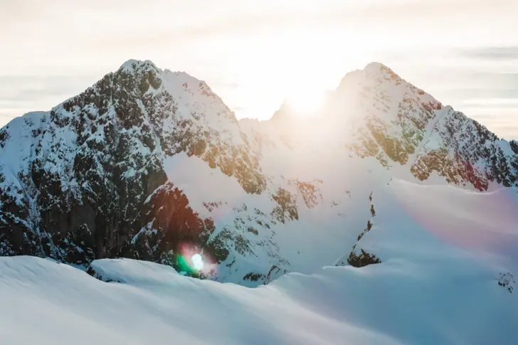 Snow-covered mountain peaks under a clear sky.