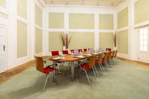 A room at the A-ROSA Travemünde with a table and chairs.
