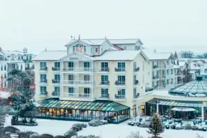 A building in the snow with trees in the background.