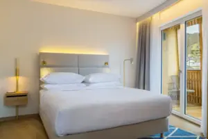 Sleeping area A bed in a bedroom with bed linen and pillows.