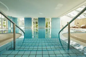 A large indoor swimming pool with steps.
