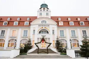 Exterior view of the A-ROSA Hotel Kurhaus Binz at Christmas, with festive decorations.