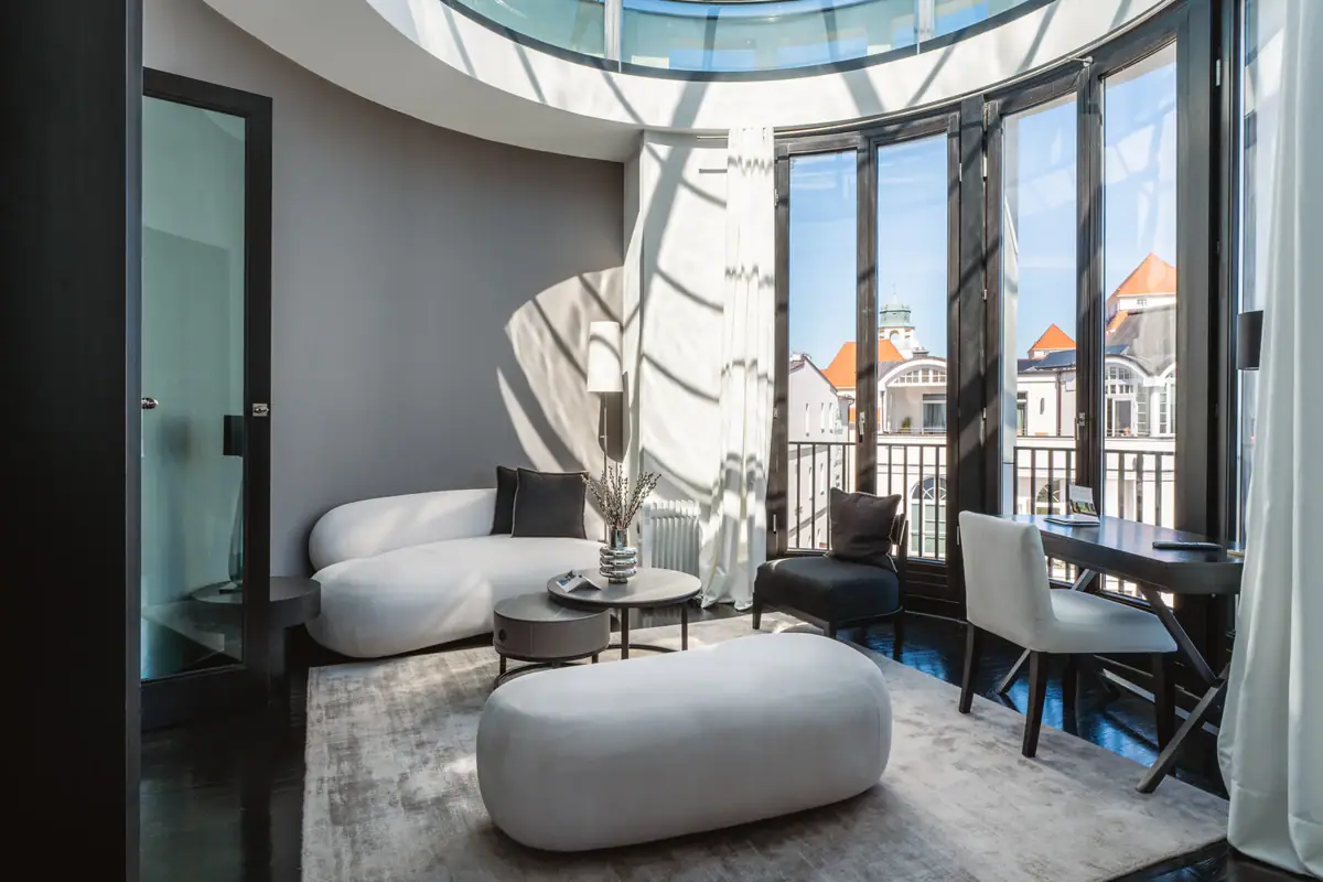Aurora Suite Living room with a glass ceiling and a large window, featuring a couch and coffee table.
