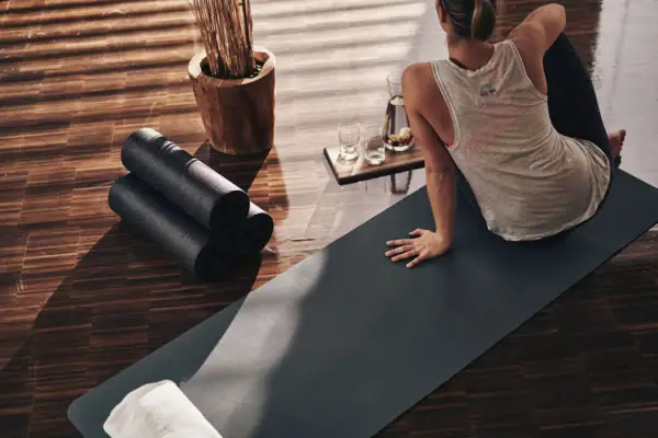 Woman sitting on yoga mat