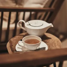 Teacup with saucer on a table.