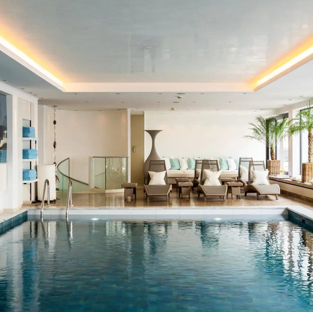 The wellness area at A-ROSA Zürs, featuring a swimming pool and stylish design.
