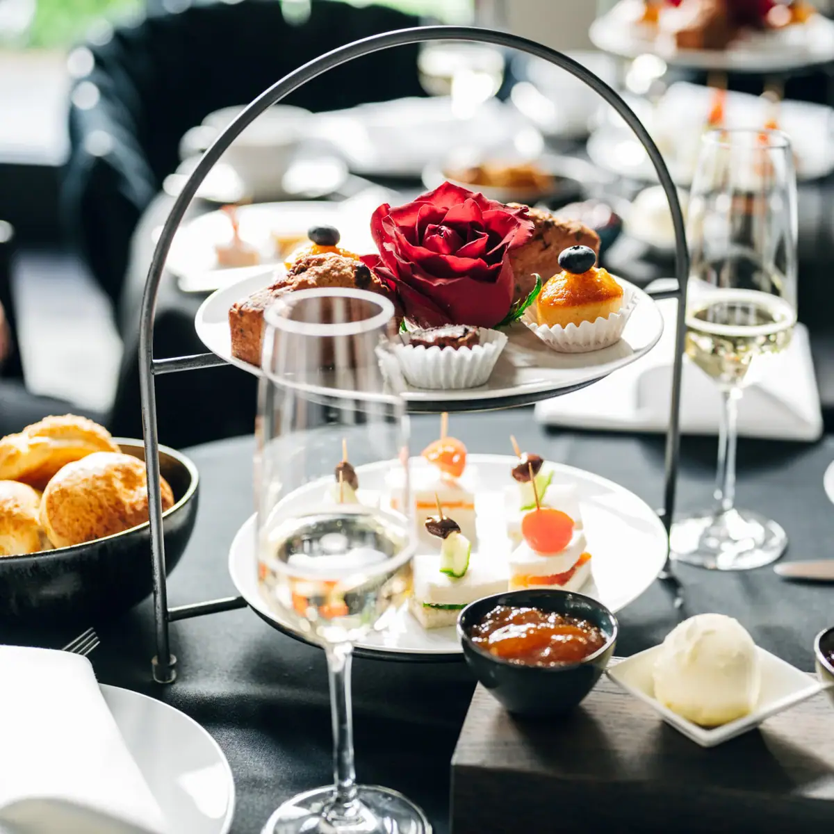 A tray of food and drinks on a table with tableware and serveware.