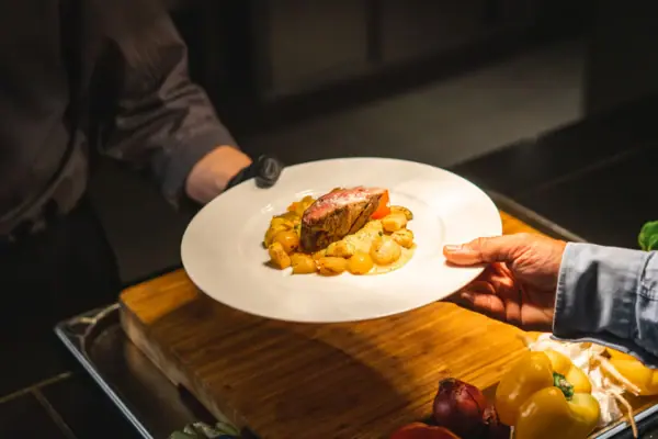 A person holds a plate of food.