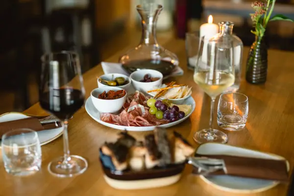 A table with food and wine glasses.