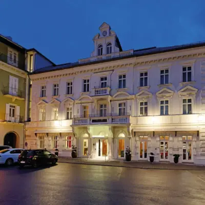 A building with an illuminated façade at night.