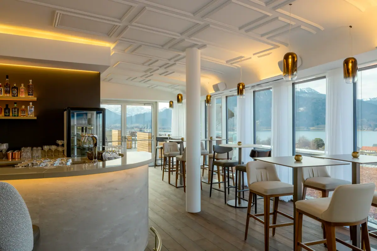 A room with a bar and chairs.