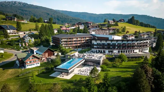 Building with swimming pool in the middle of a mountain village.