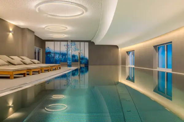 Wellness area at A-ROSA Tegernsee The wellness area at A-ROSA Tegernsee, featuring a pool and sun loungers alongside it.