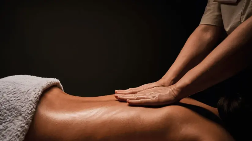 Person receives a massage in an indoor room.