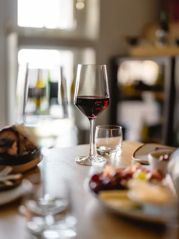 A glass of wine on a table.