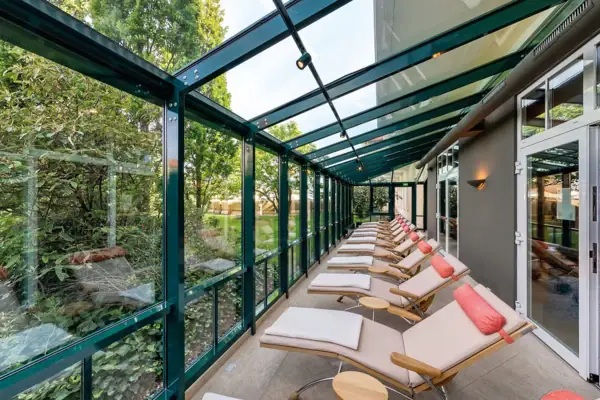 A row of deckchairs in a room with glass walls.