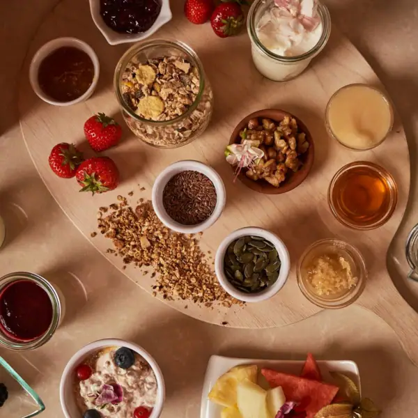 A table set with a variety of foods, including bowls and platters.