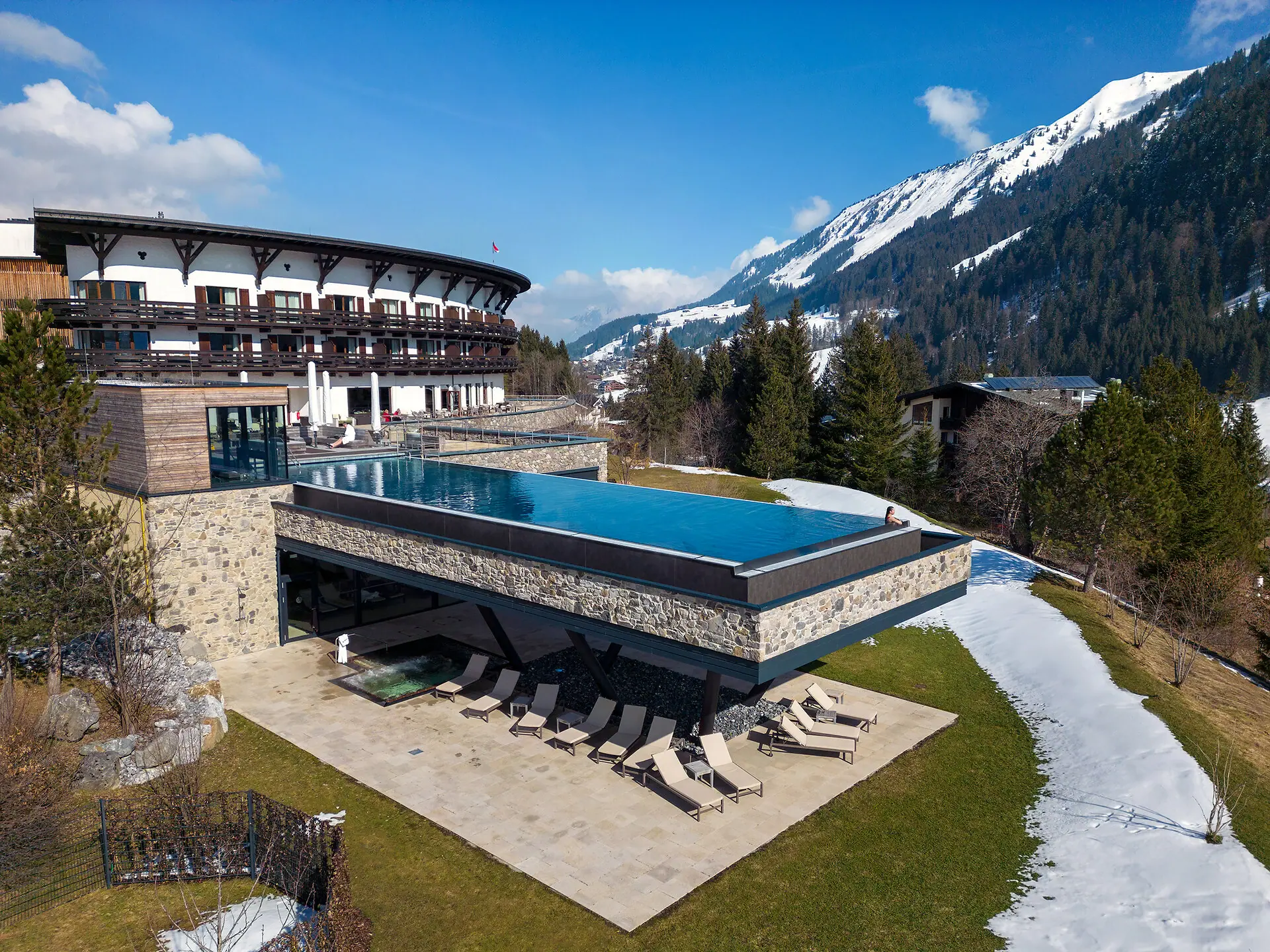 A swimming pool inside a building, with a mountain in the background.