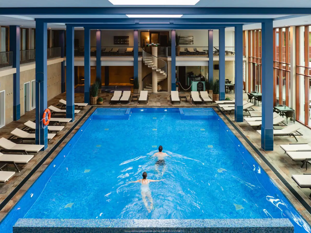 Indoor pool Couple swimming in a leisure center pool.