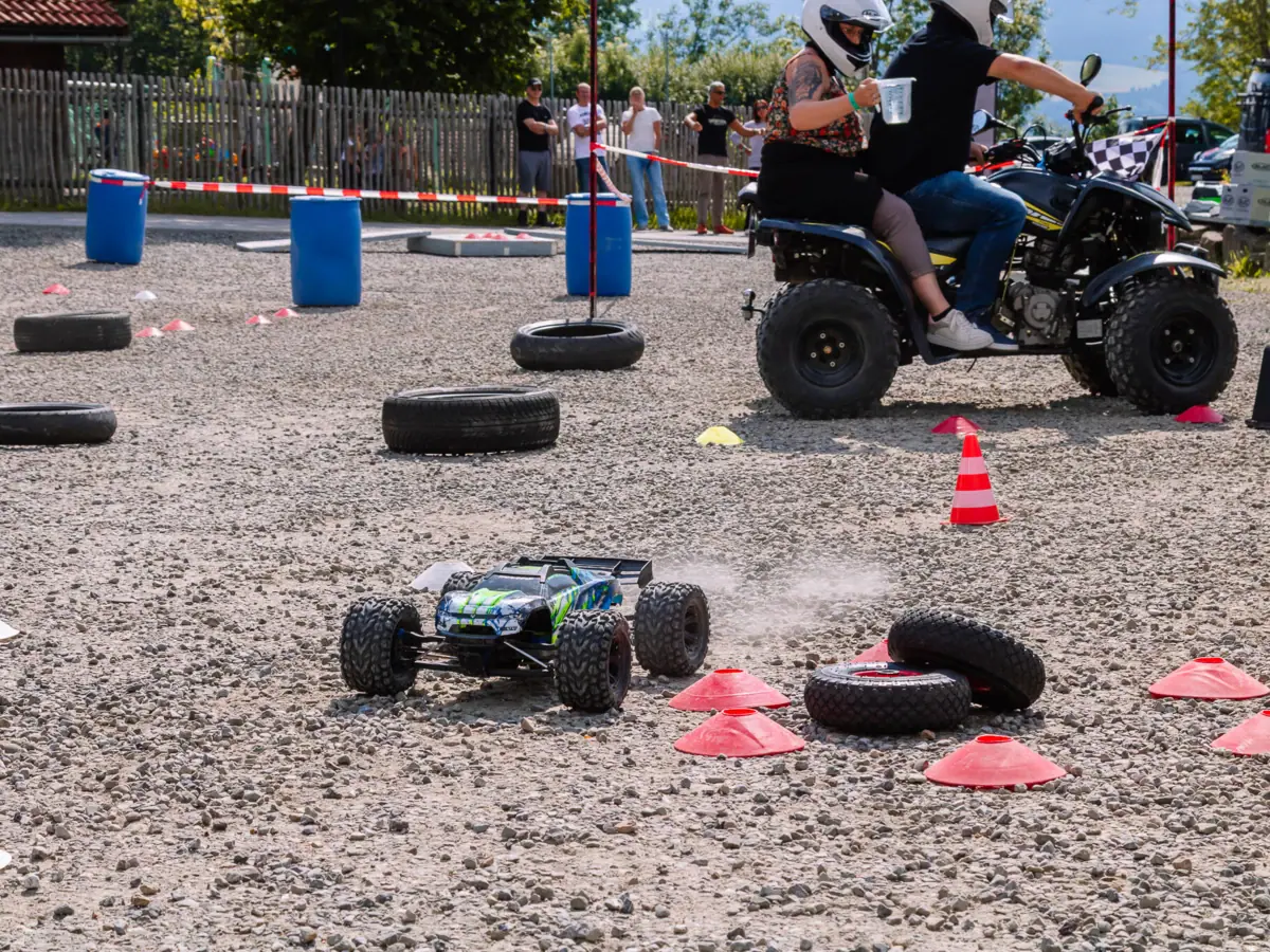 A couple on a quad bike outdoors.