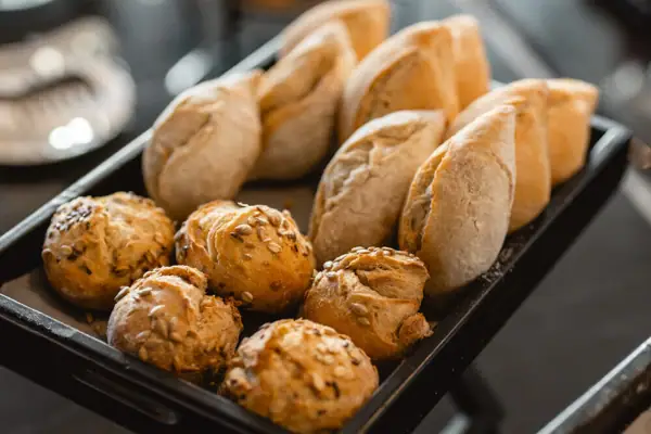 A tray of assorted baked bread on a table.