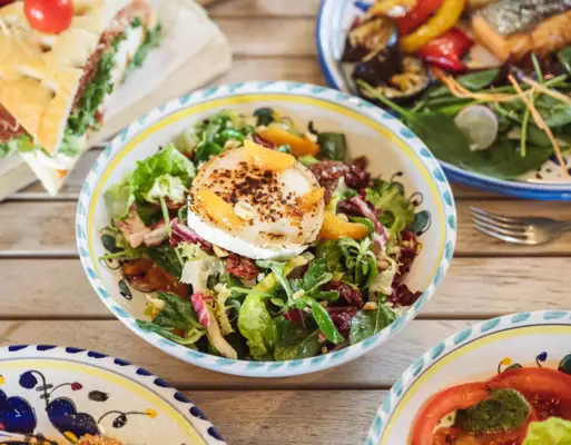 A fresh salad in a bowl with mixed greens and tomatoes.