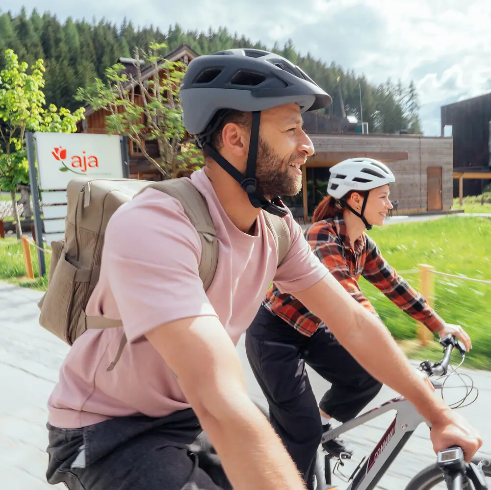 A man and a woman are cycling.