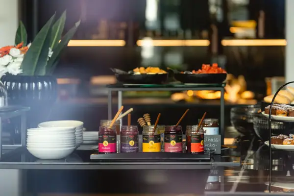 Jars of jam and bowls on a table.