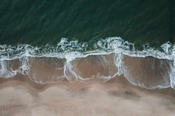 A coastal landscape on Sylt with waves breaking on a beach