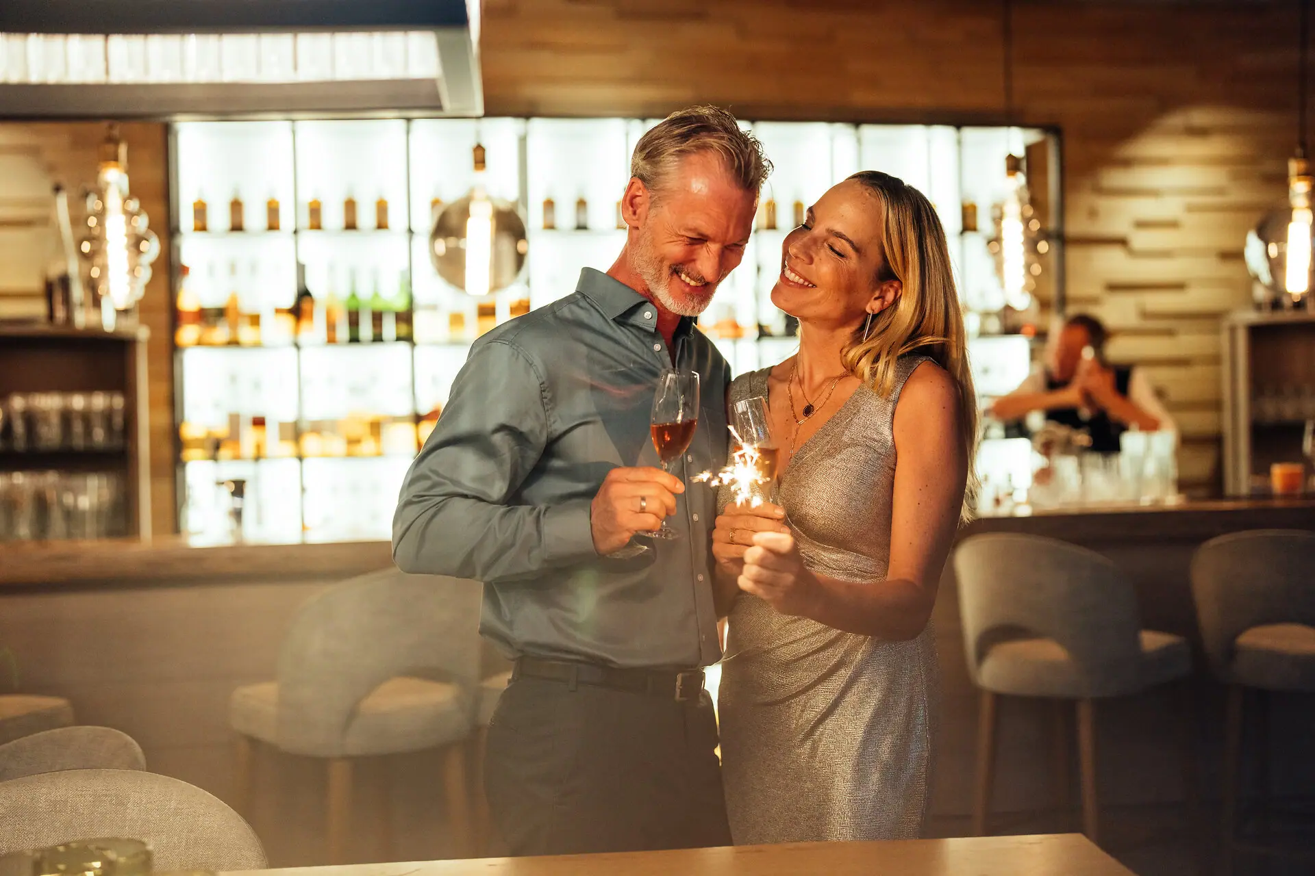 A man and a woman are holding glasses of champagne.
