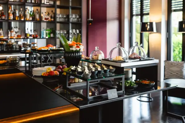 Buffet table with assorted food and bottles.