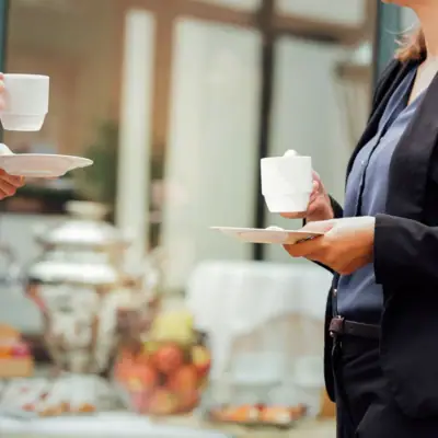 Woman holding a cup of coffee indoors.