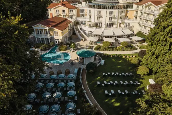 Aerial view of a building with two pools