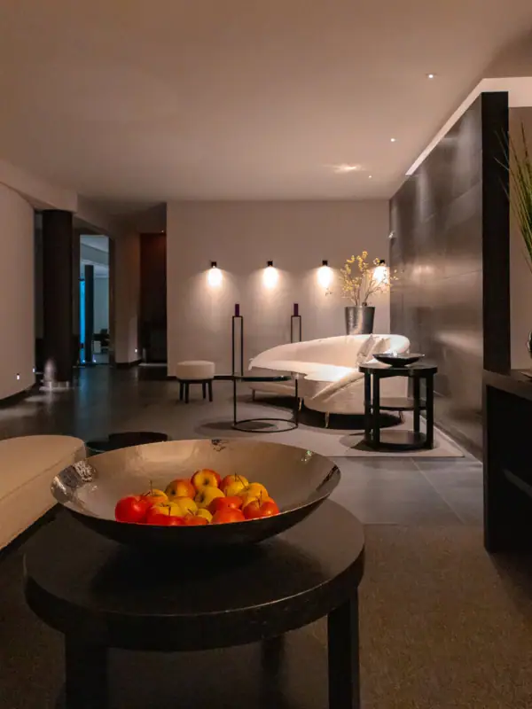 A bowl of fruit on a coffee table in a well-designed room.