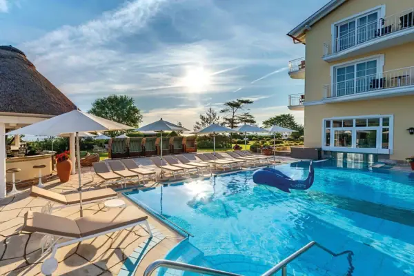 An outdoor pool with sun loungers at the Wellnesshotel Kühlungsborn